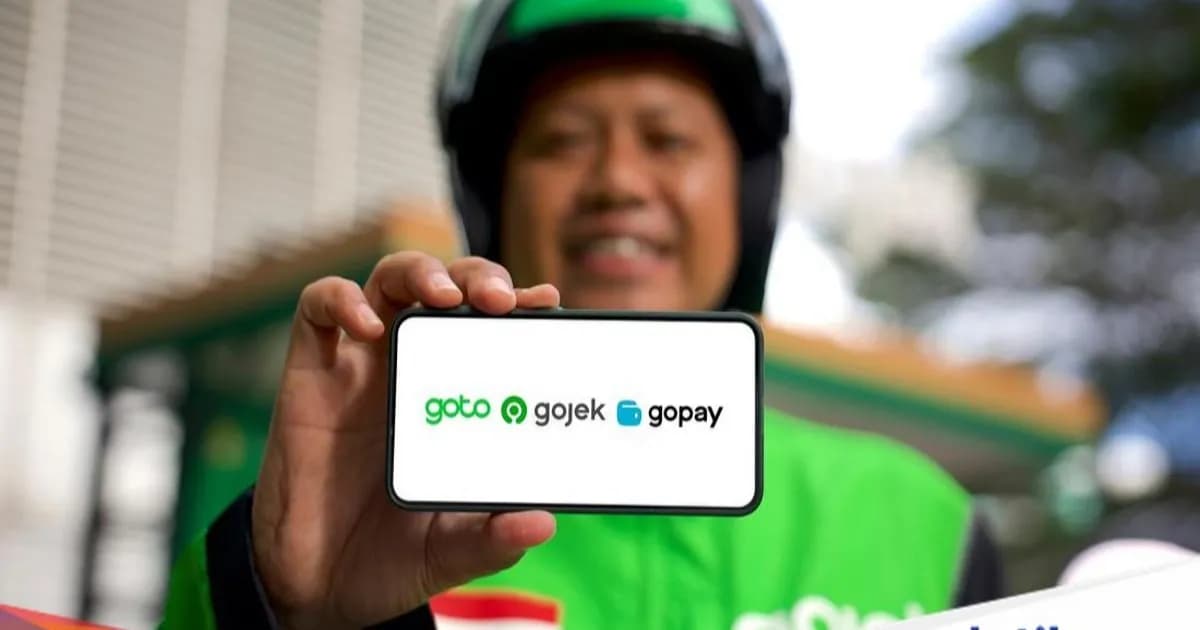 Ilustrasi logo PT GoTo Gojek Tokopedia Tbk (GOTO) dengan latar belakang grafik keuangan